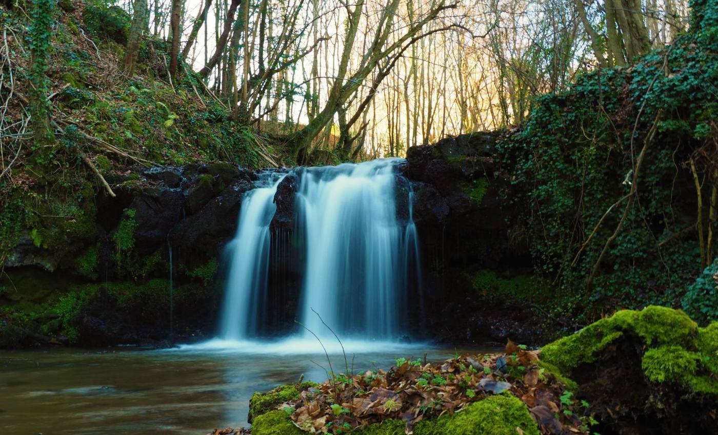 Wasserfall im sonnendurchfluteten Wald